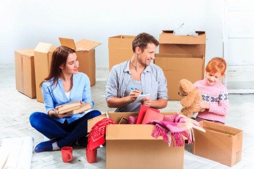 Professional movers handling household items in London